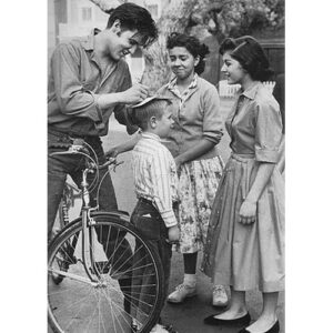 Elvis signing an autograph on his bike